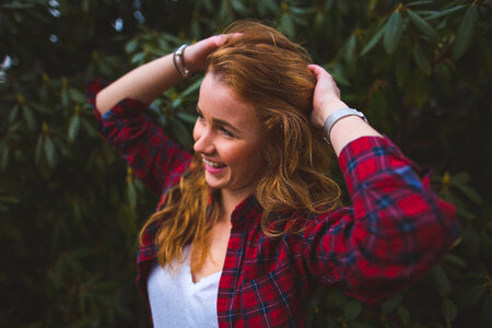 Portrait of a Happy Redhead Girl in Plaid Shirt photo