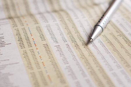 Pen newspapers stock market photo