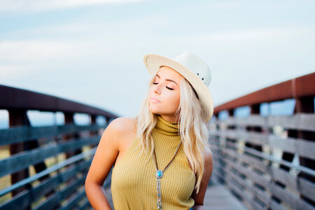 Young Blonde Girl with Cowboy Hat on the Bridge photo