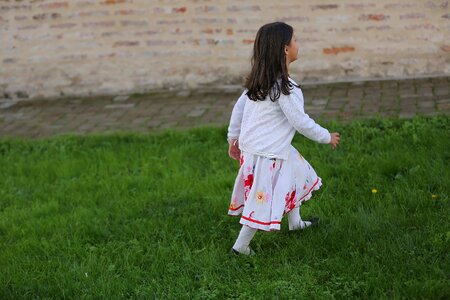 Child walking grassy photo