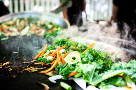 Grilling vegetables at street food market photo