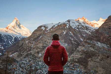 Man in Red Jacket looking at the Alps in Zermatt, Switzerland photo