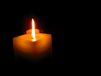 Fire illuminated light of a candle photo