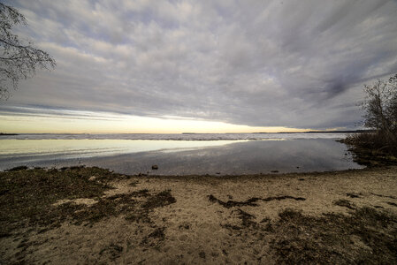 Beach and Great Slave lake under dramatic clouds photo