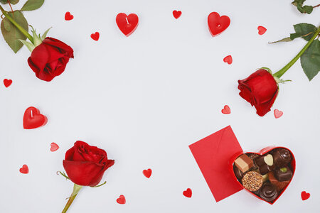 Valentine’s Day. Roses, hearts and box of chocolate on white background.