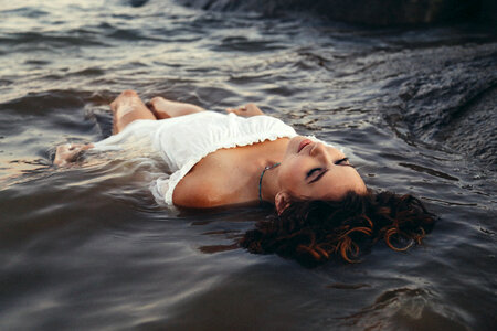 Young Woman Floating in Lake photo