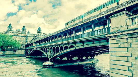 Train Passing on Famous Pont De Bir-Hakeim Bridge, Paris photo