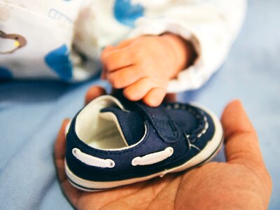 Baby hands shoe photo