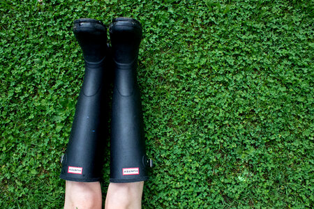 Person Wearing Wellington Boots Lying on Grass photo