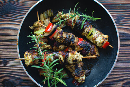 Chicken skewers on a wooden background