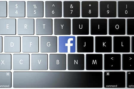 Facebook icon on laptop keyboard. Technology concept