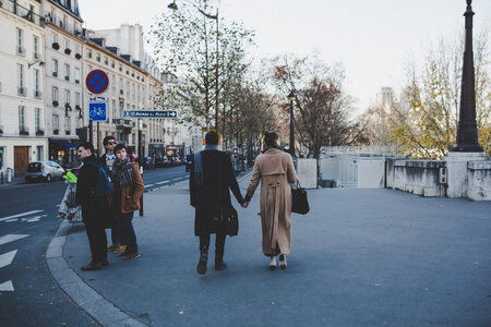 Elegant Couple Walking the Streets Holding Hands photo