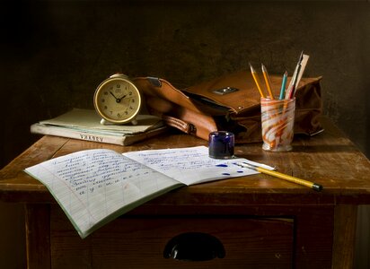 ink pen in open notebook on white wooden table. photo