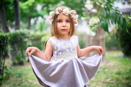 Cute Little Girl with Flower Wreath and Satin Dress photo