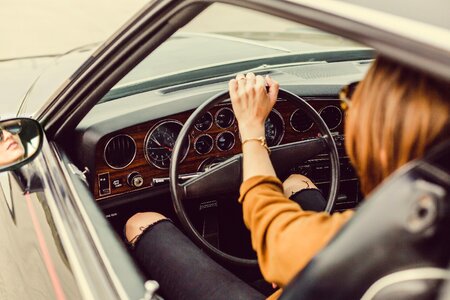 Woman driving vintage car photo