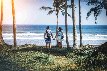 couple among palms on the tropical island of Bali photo