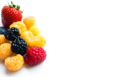 Detail of colorful healthy fresh berries on a white background photo