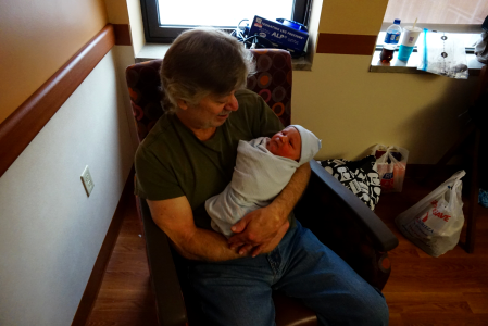 Pap holding new grandson photo