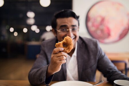 Man Holding Donut photo