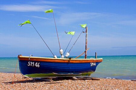 Wooden boat sails blue photo