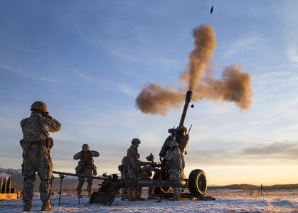 Combat Team fire a 105 mm howitzer