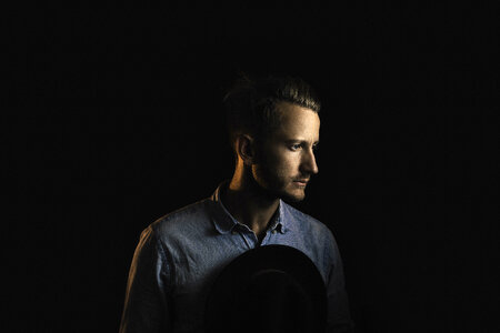Pensive Man Profile Portrait on Dark Background photo