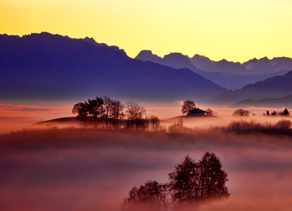 Misty Mountains Landscape with Building and Trees photo
