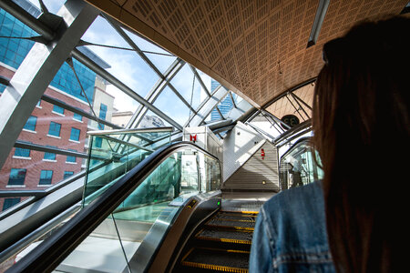 Woman on escalators at metro station photo