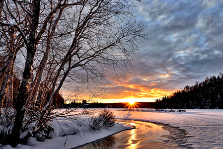 Sunset over the winter landscape with clouds photo