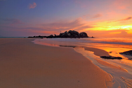 Sunset over the sandy beach photo