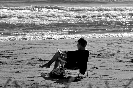 Man sitting on the beach monochrome photo
