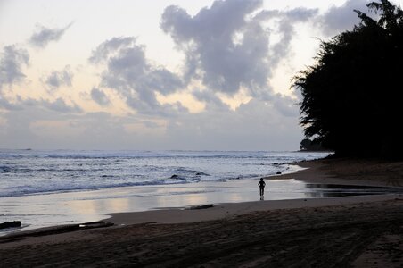 Silhouette of a person walking on the beach on Kauai