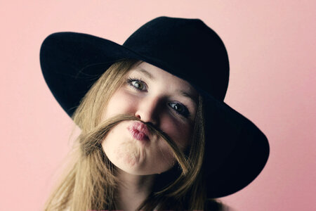 Portrait of Young Girl with Moustache Made of Hair photo
