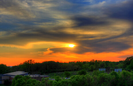 Orange sunset behind clouds in the distance in Southern Wisconsin