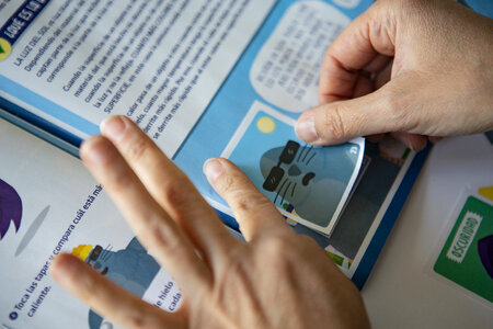 A man pasting stickers into the collection album