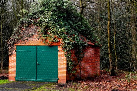 Overgrown bricks stone built house photo