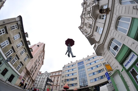 Flying statue of a man with umbrella in Prague photo