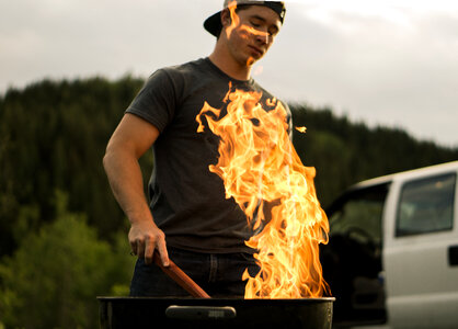 Young Man Burns the Grill Outdoors photo