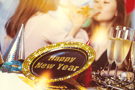 Happy New Year Concept. Two young girls holding glasses of champagne making a toast. photo