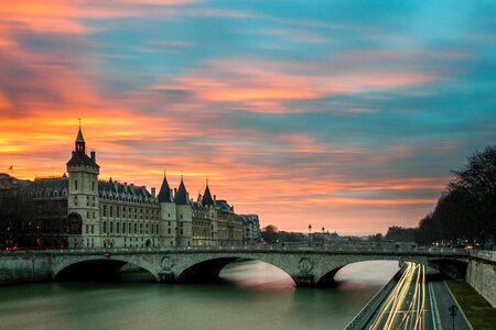Evening View of a Parisian Bridge and Traffic Lanes along the Seine photo