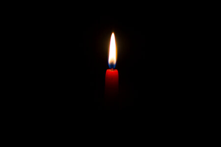 Red Candle against Black Background photo