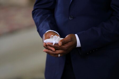 Man wedding ring holding photo
