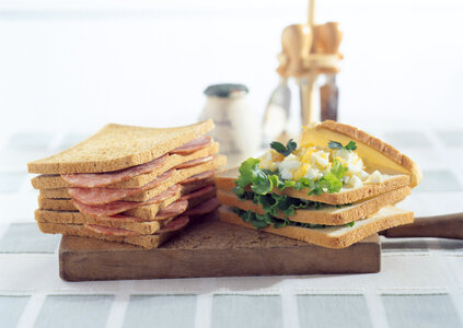 Freshly made clubsandwiches served on a wooden chopping board photo