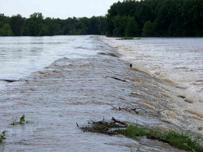 Flood waters spilling out over the bank photo