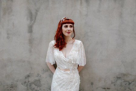 Bride with Red Hair Against Gray Wall