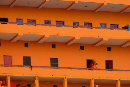 Monk Dressed in Orange Living in an Orange Building photo