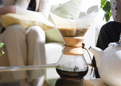 Black coffee and coffee filters with coffee ground in livingroom photo