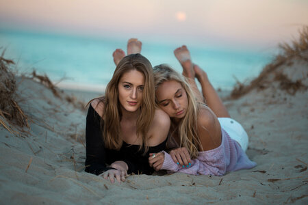 Two Happy Girls Lying on a Dune photo