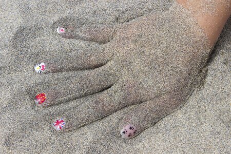 Sand child's hand beach photo