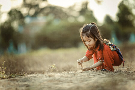 Little Asian Girl Playing with Sand photo